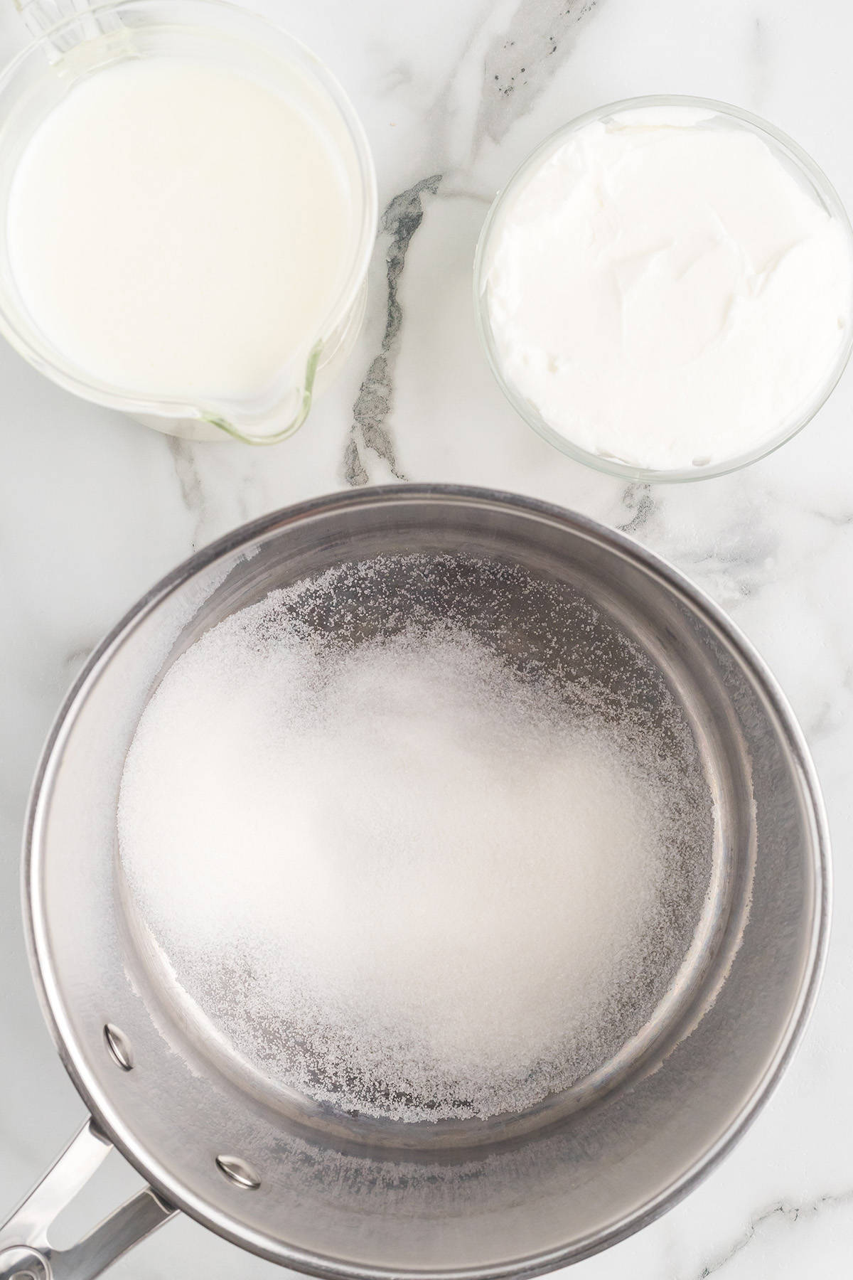 Adding ingredients to a saucepan.