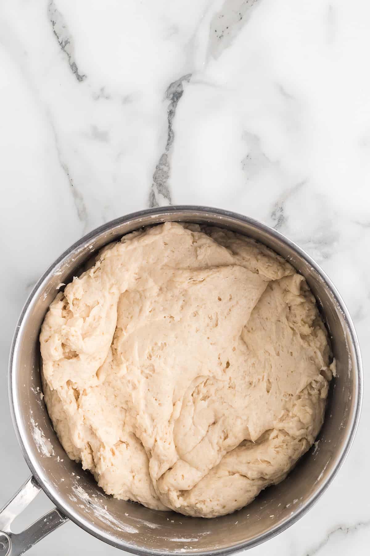 Wet and dry ingredients combined in a mixing bowl.