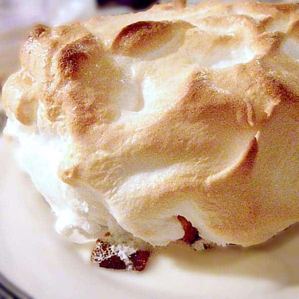 A serving of Baked Alaska on a white plate.