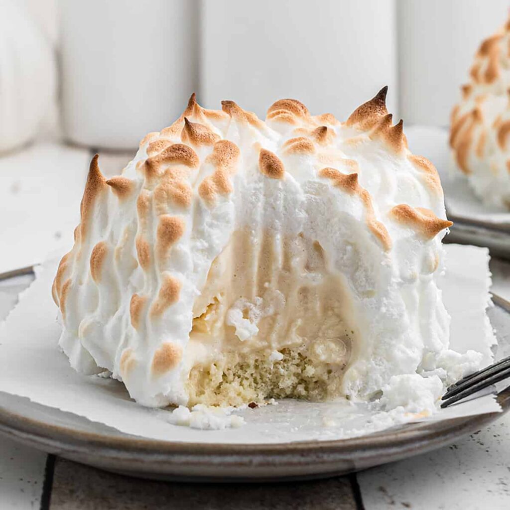 Finished Baked Alaska on a white serving plate.