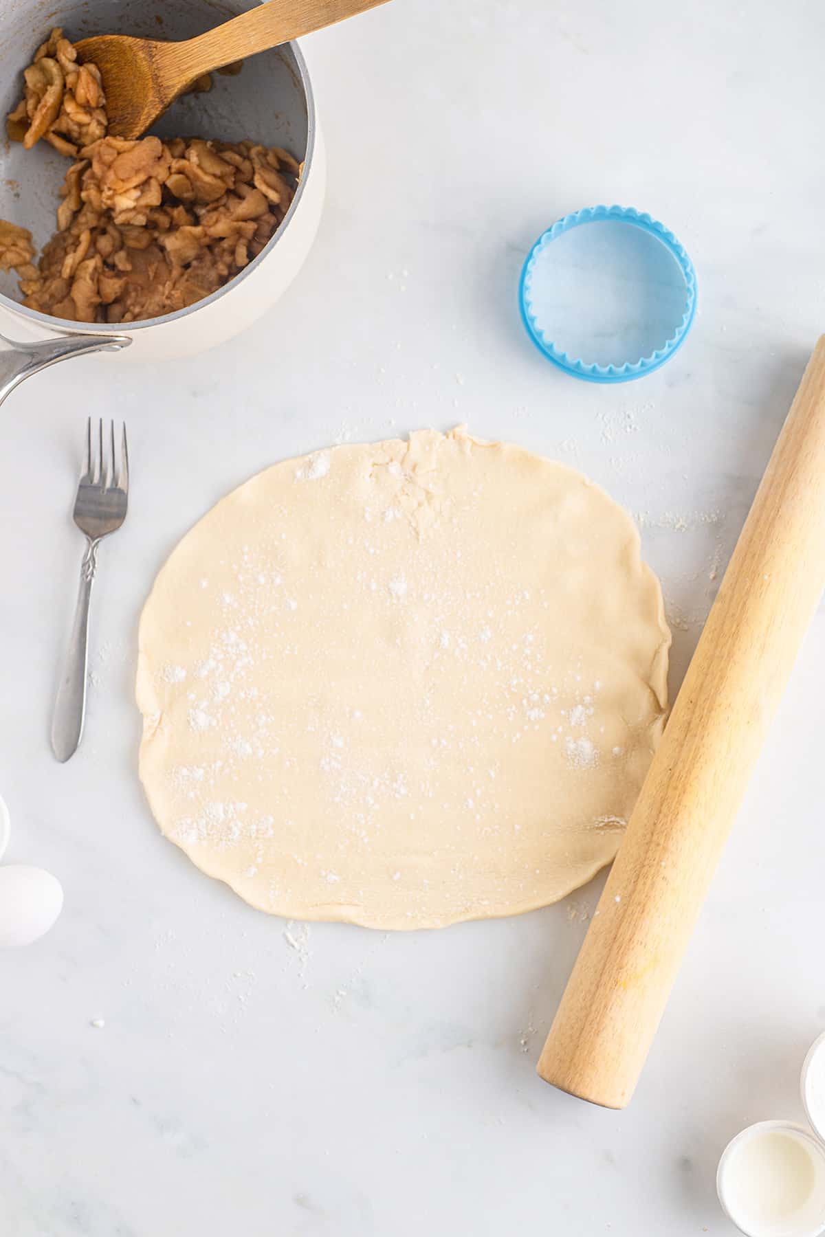 Pie crust rolled out on a floured surface.