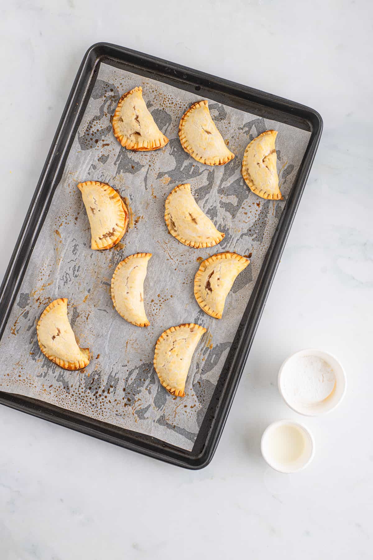 Baked pies waiting to be glazed.