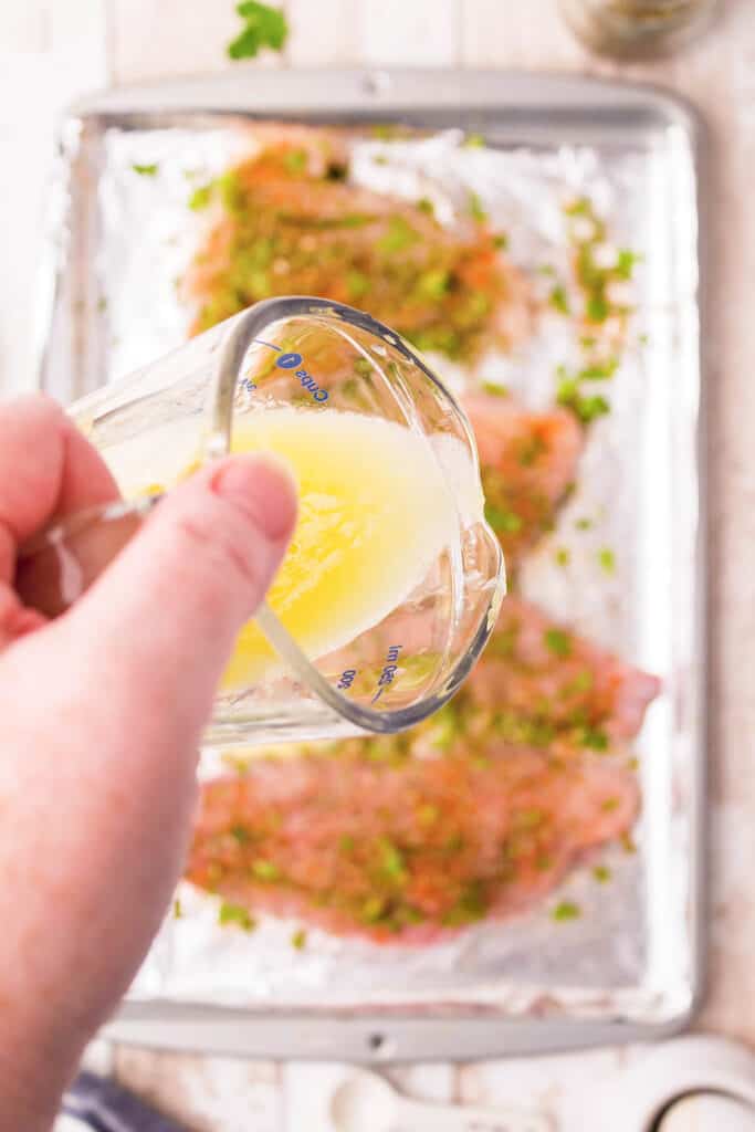 Pouring lemon and butter over the fillets.