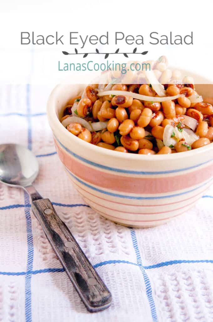 Black Eyed Pea Salad in a vintage serving bowl set on a kitchen towel.