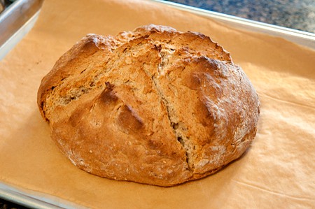 Beautiful and golden brown Irish Soda Bread on a baking sheet