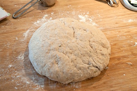 Dough shaped into a round on a lightly floured board