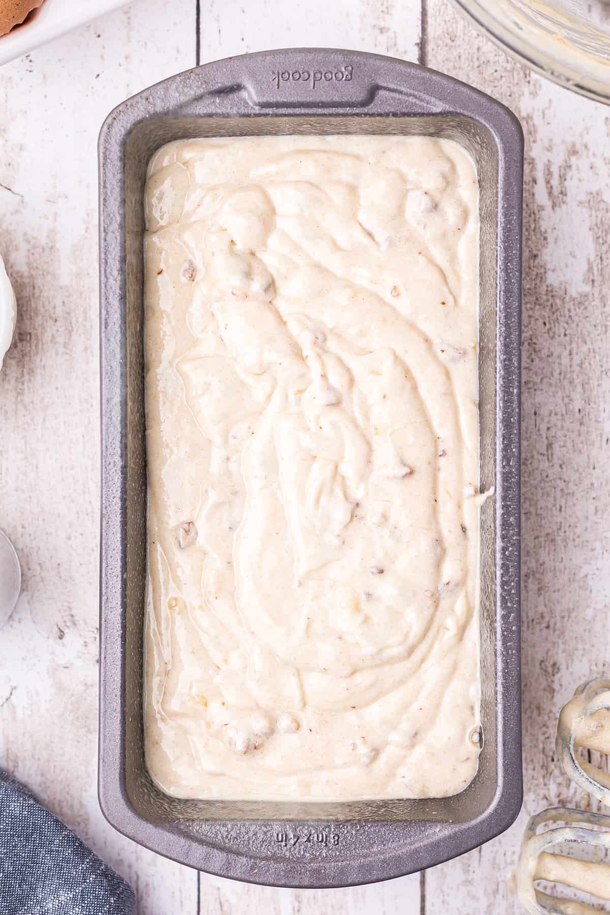 Buttermilk banana nut bread batter in a prepared loaf pan.