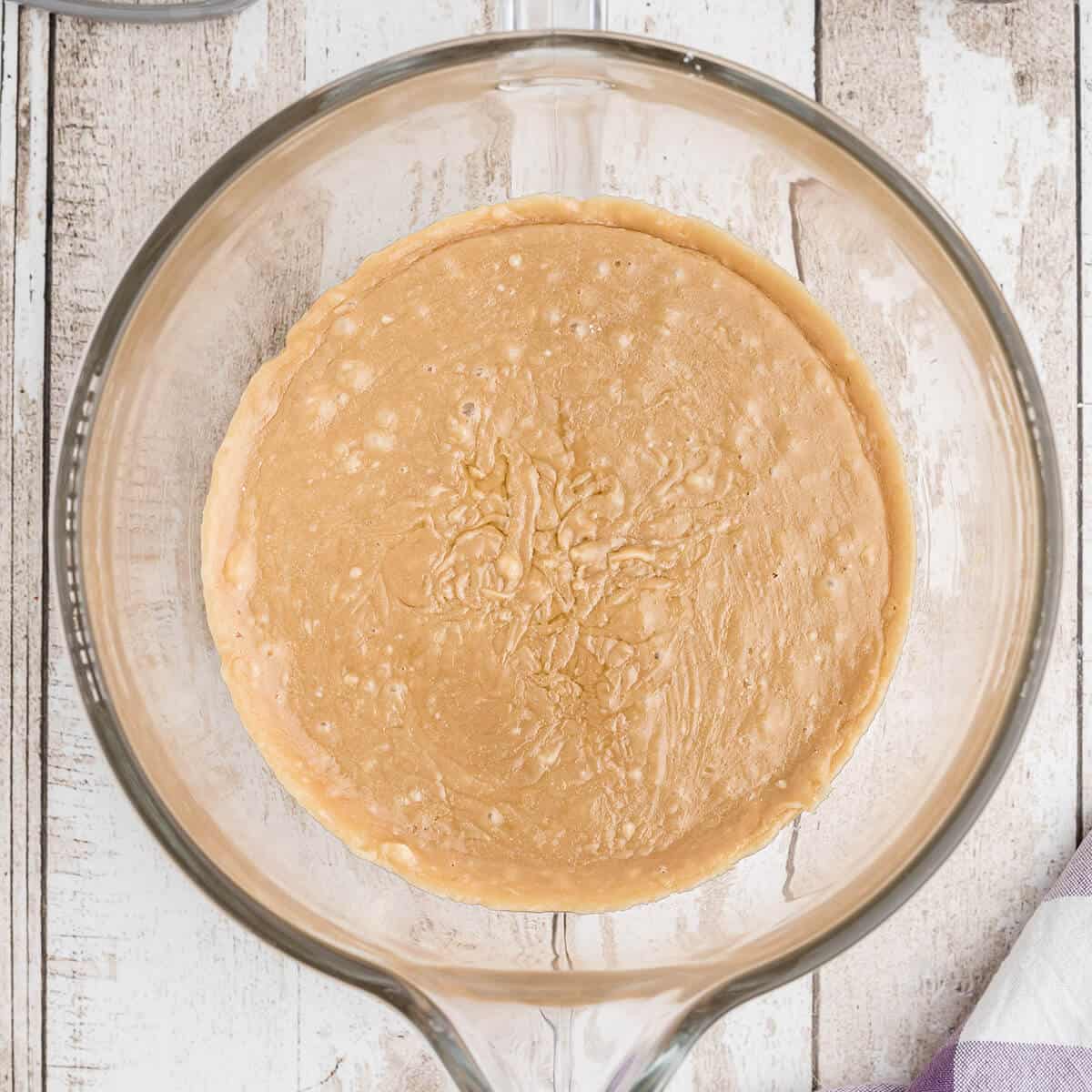 Frosting mixture in a mixer bowl.