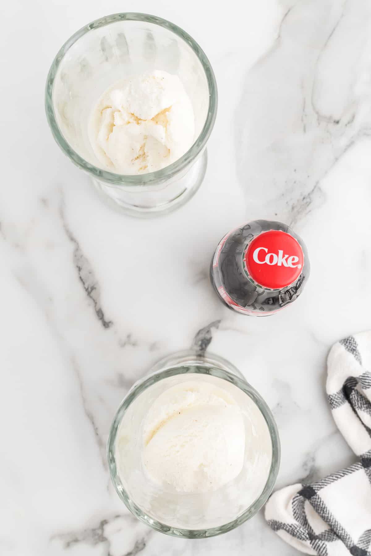 Two soda glasses filled with ice cream.