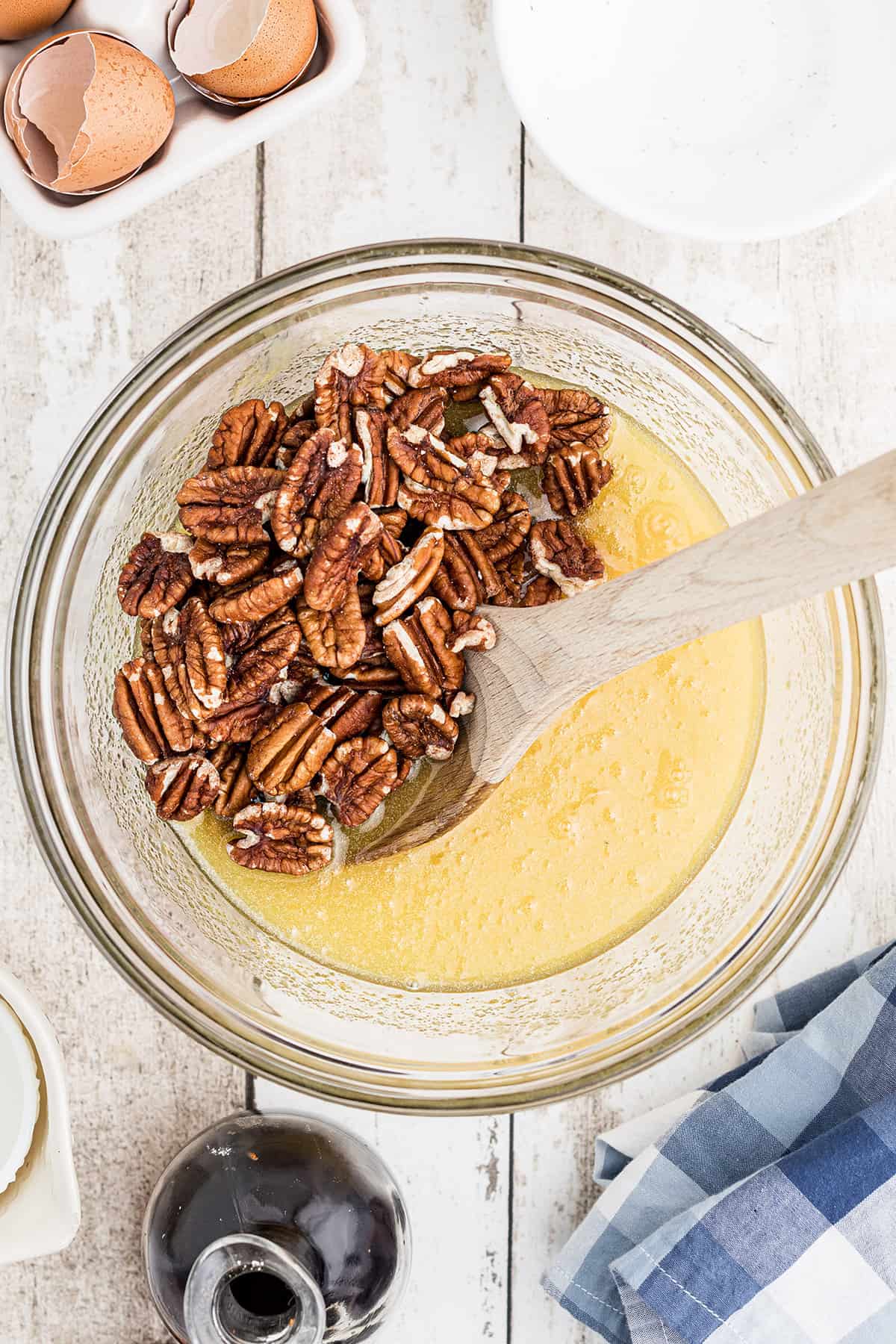 Mixing pecans into the filling mixture.