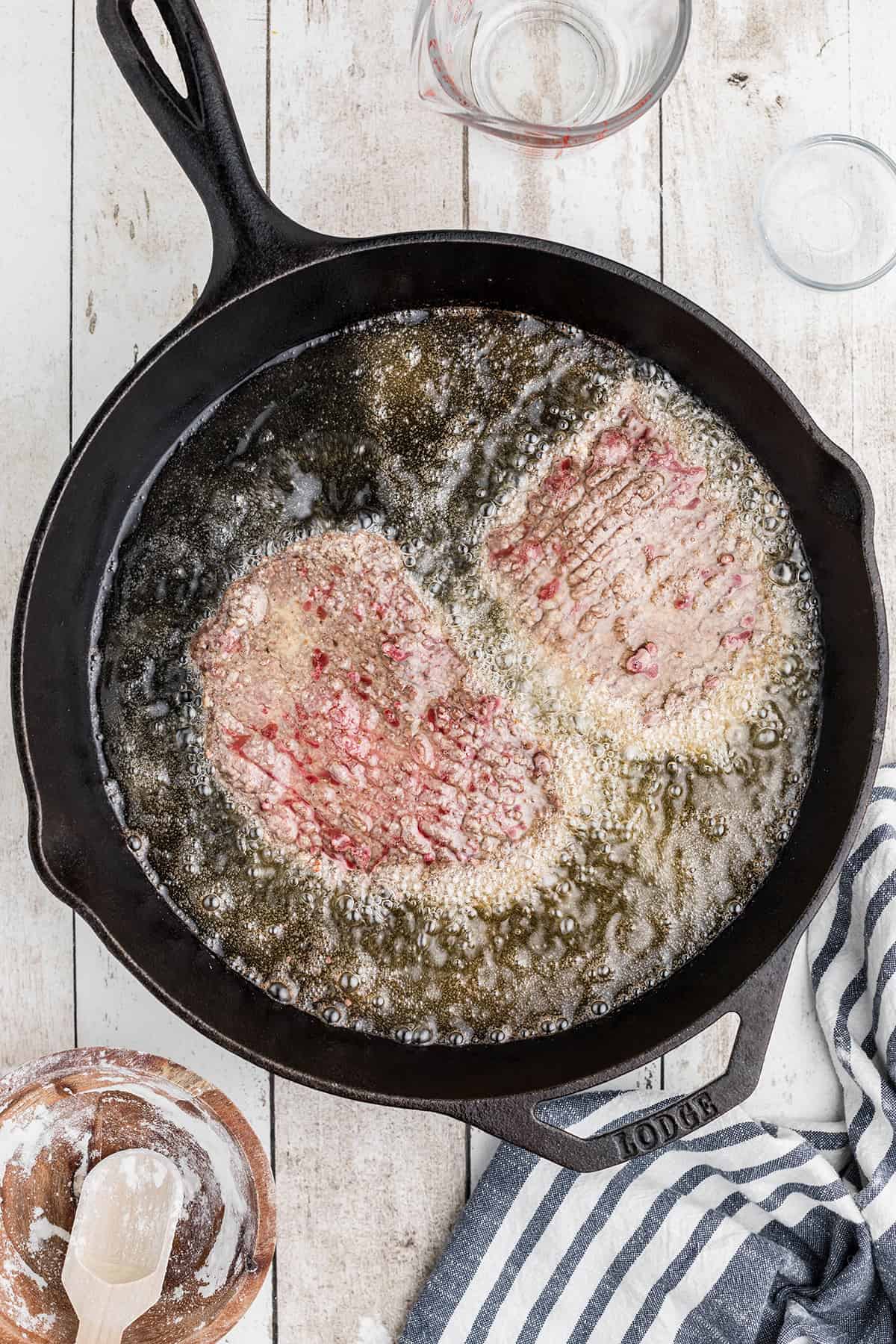 Steak cooking in hot oil.