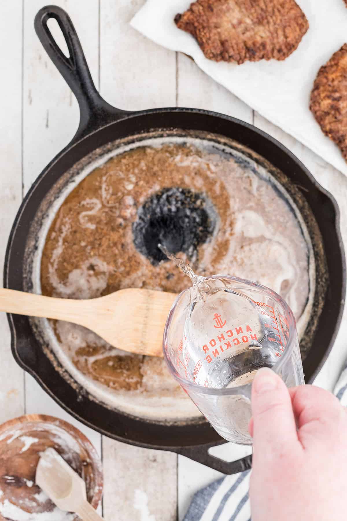 Adding water to finish gravy.