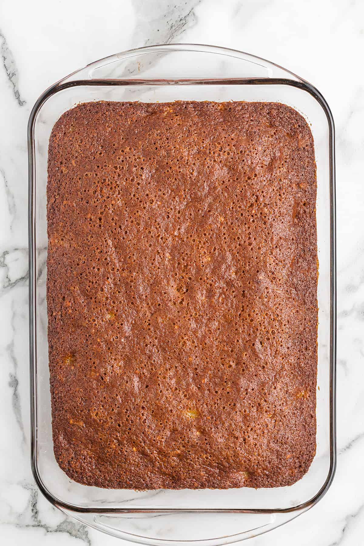 Baked cake base in the baking dish.