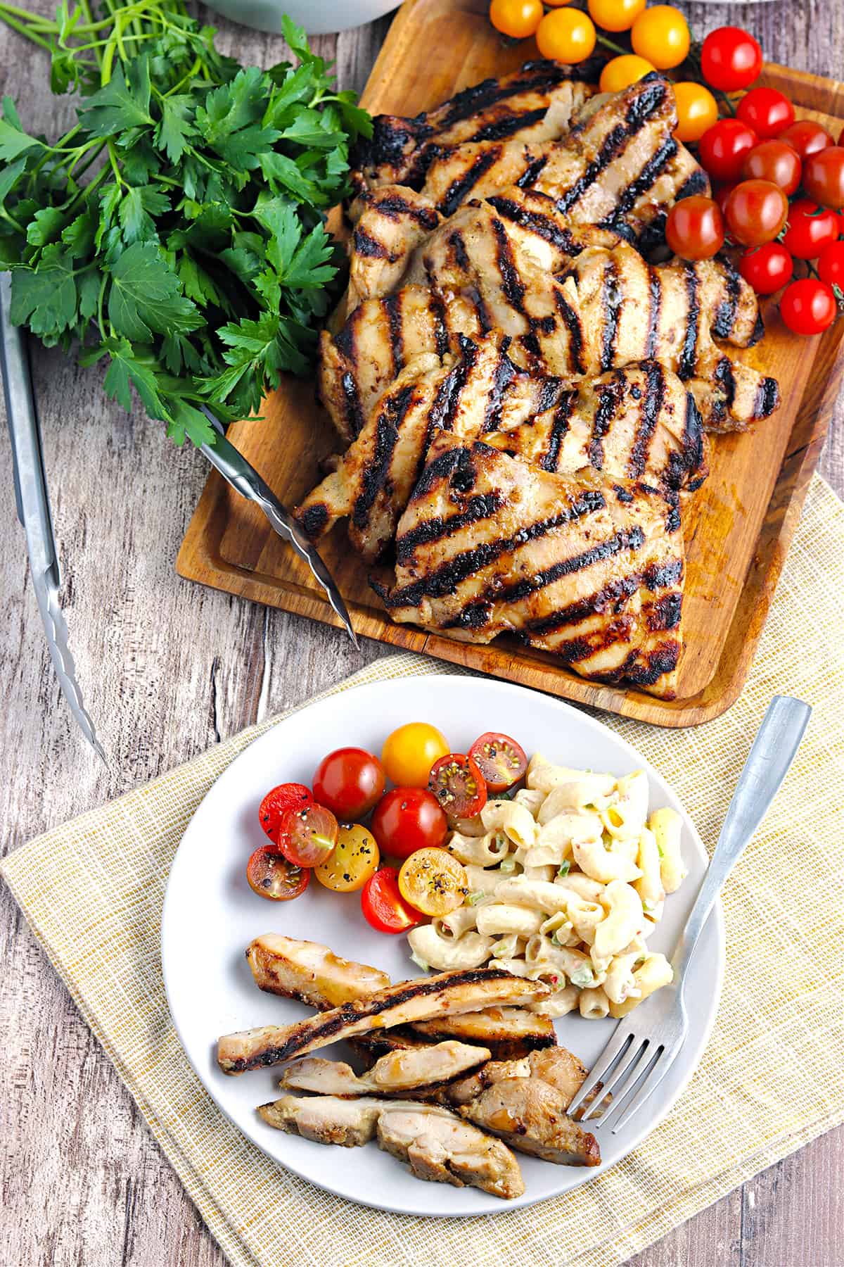 Sliced grilled chicken thighs on a white plate.