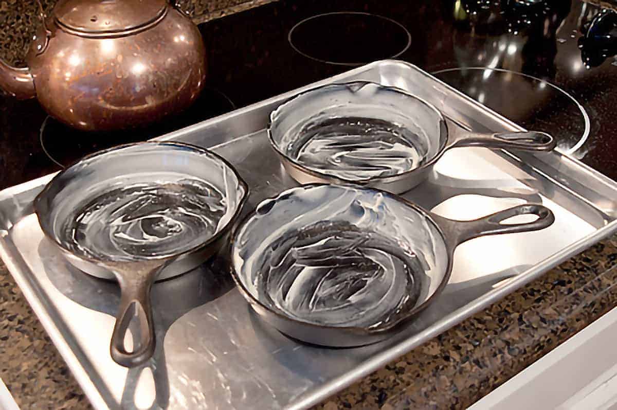 Three mini skillets on a baking sheet; each liberally coated with butter.