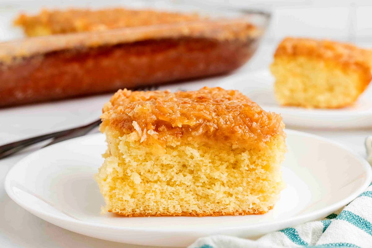 A slice of lazy daisy cake on a white plate.