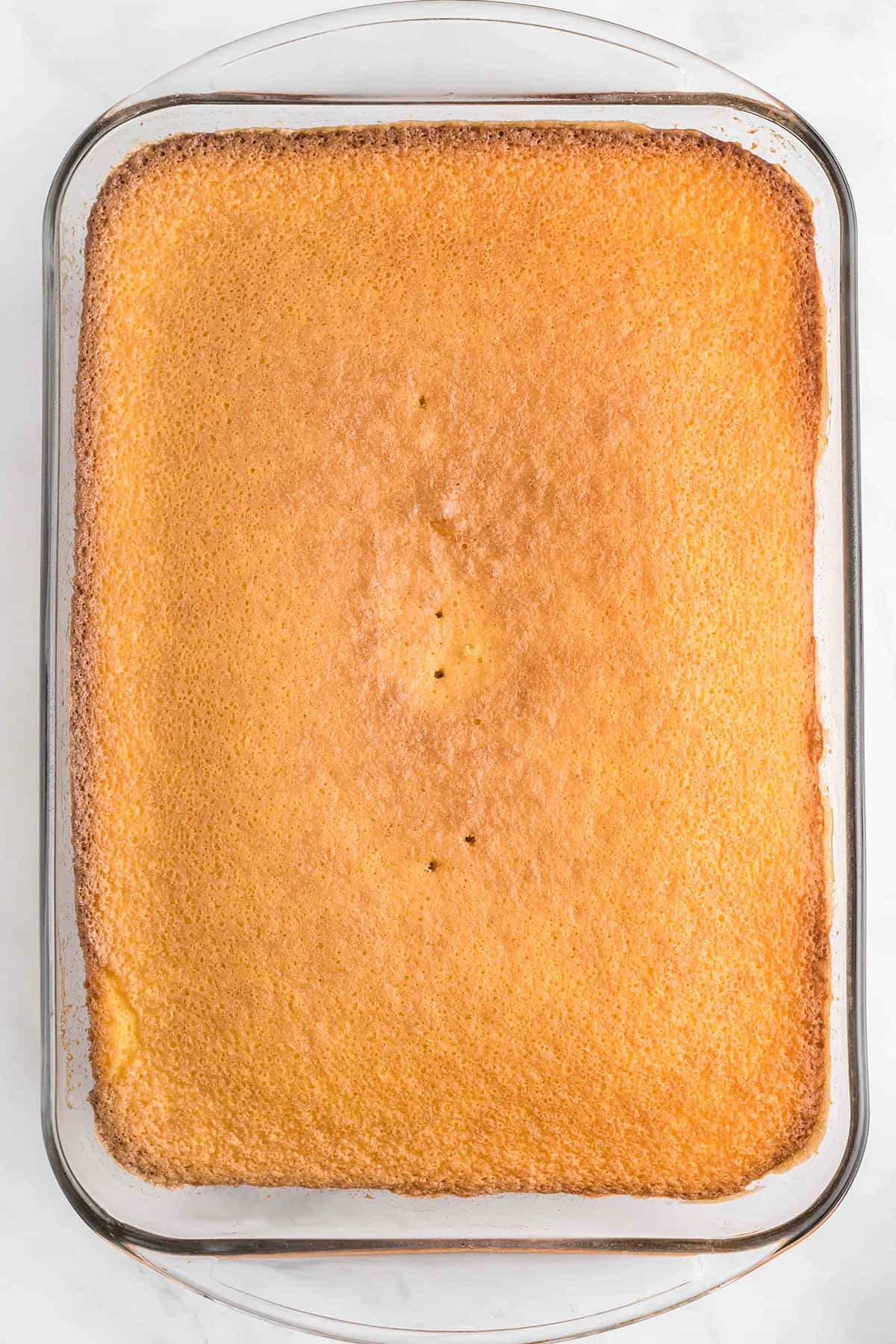 Cooked cake cooling in a baking dish.