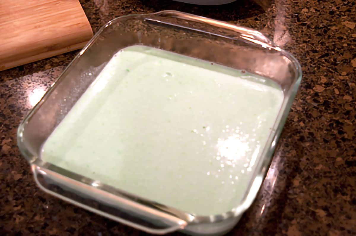 Jello and cream cheese mixture in an 8x8 glass dish.