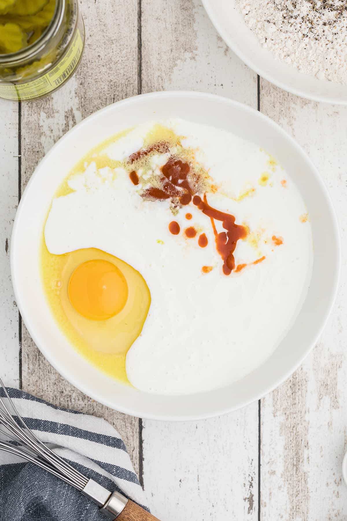 Egg and buttermilk mixture in a shallow bowl.