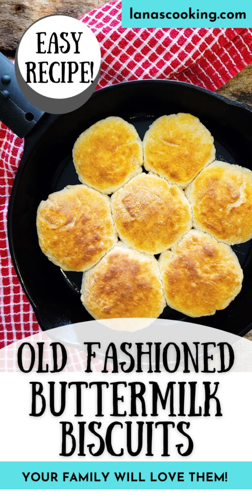 Baked buttermilk biscuits in a cast iron skillet on a wooden board.