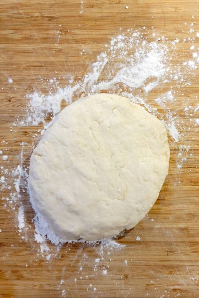 Biscuit dough turned out onto a lightly floured board.