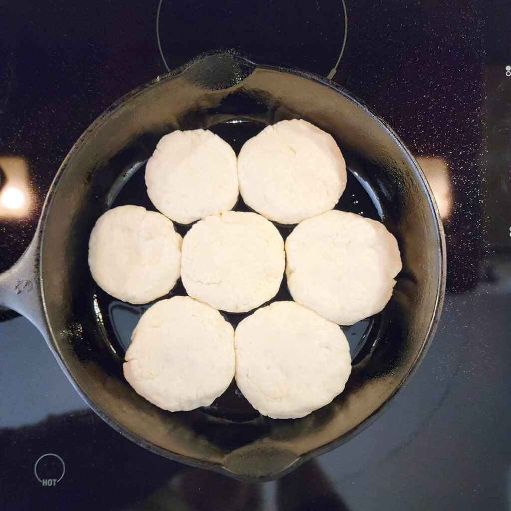 Formed biscuits in a cast iron skillet.