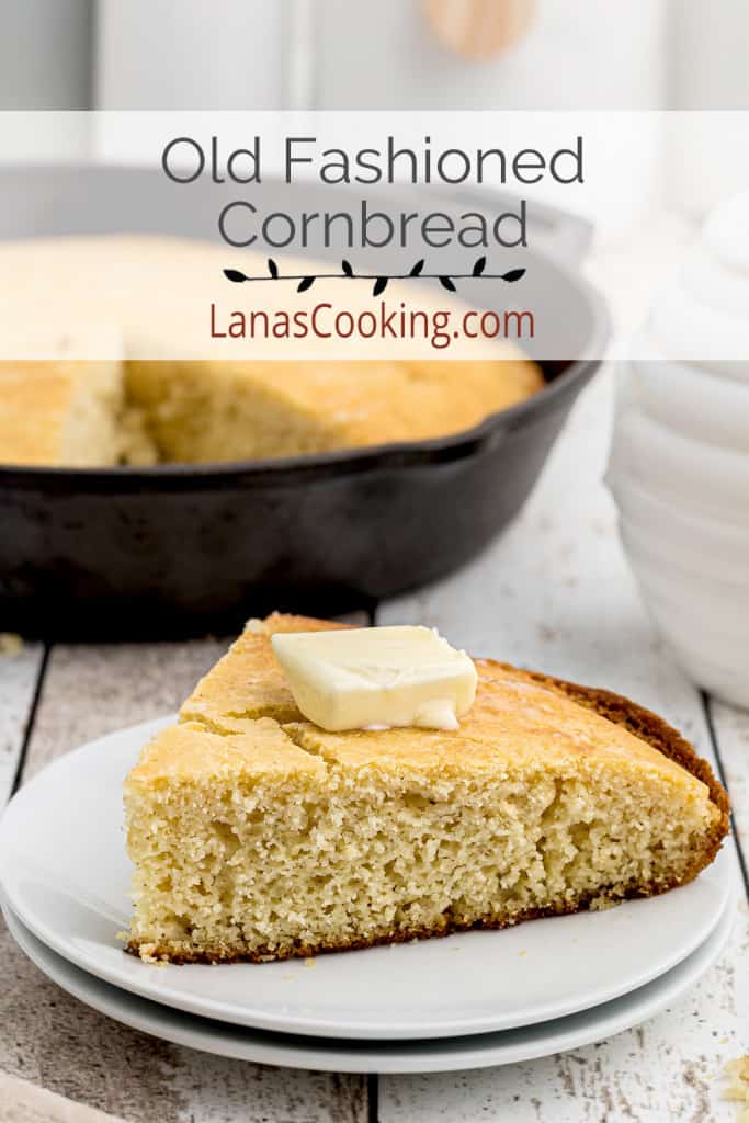 A slice of cornbread topped with a pat of butter.