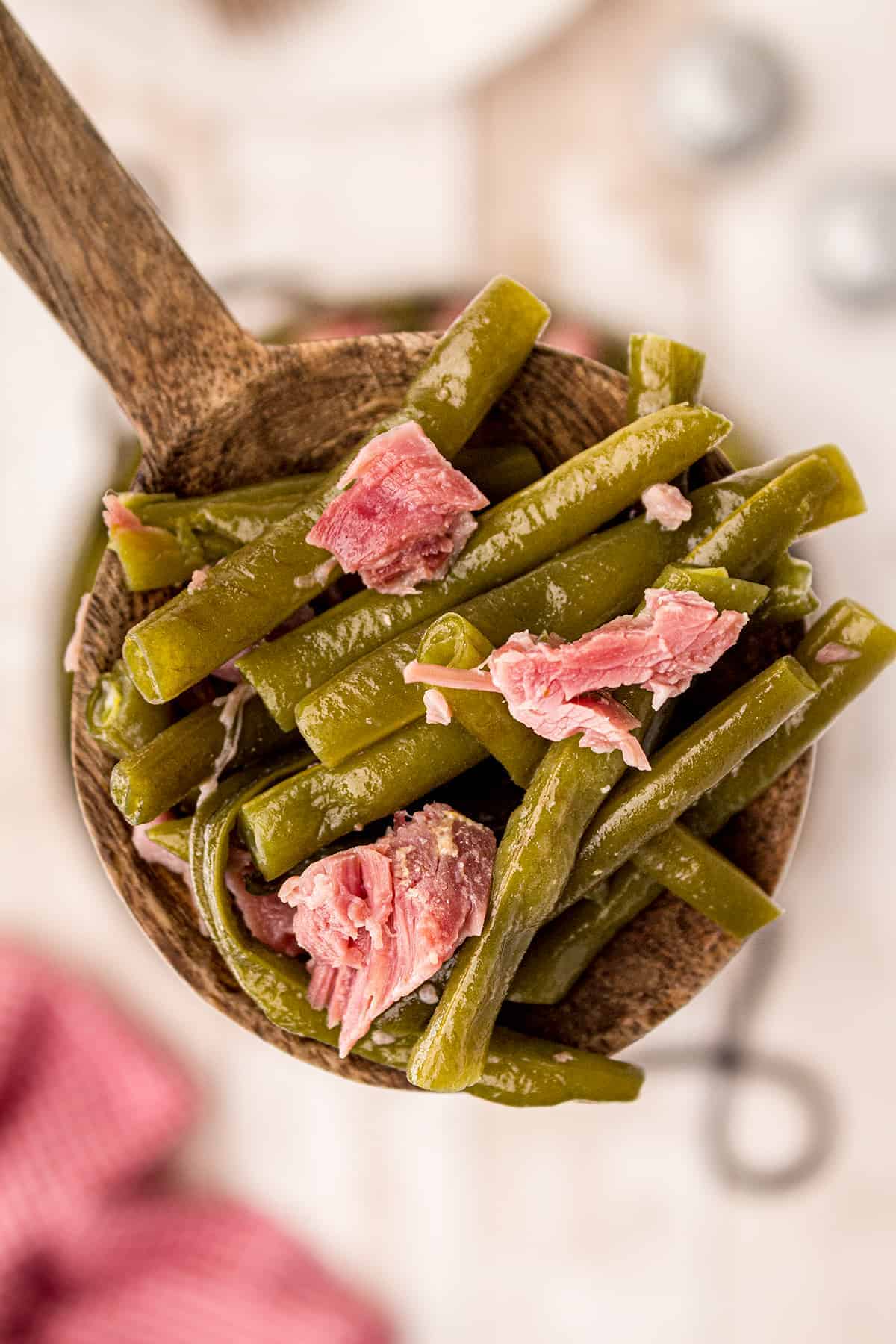 Closeup of a wooden spoonful of Old Fashioned Southern Style Green Beans