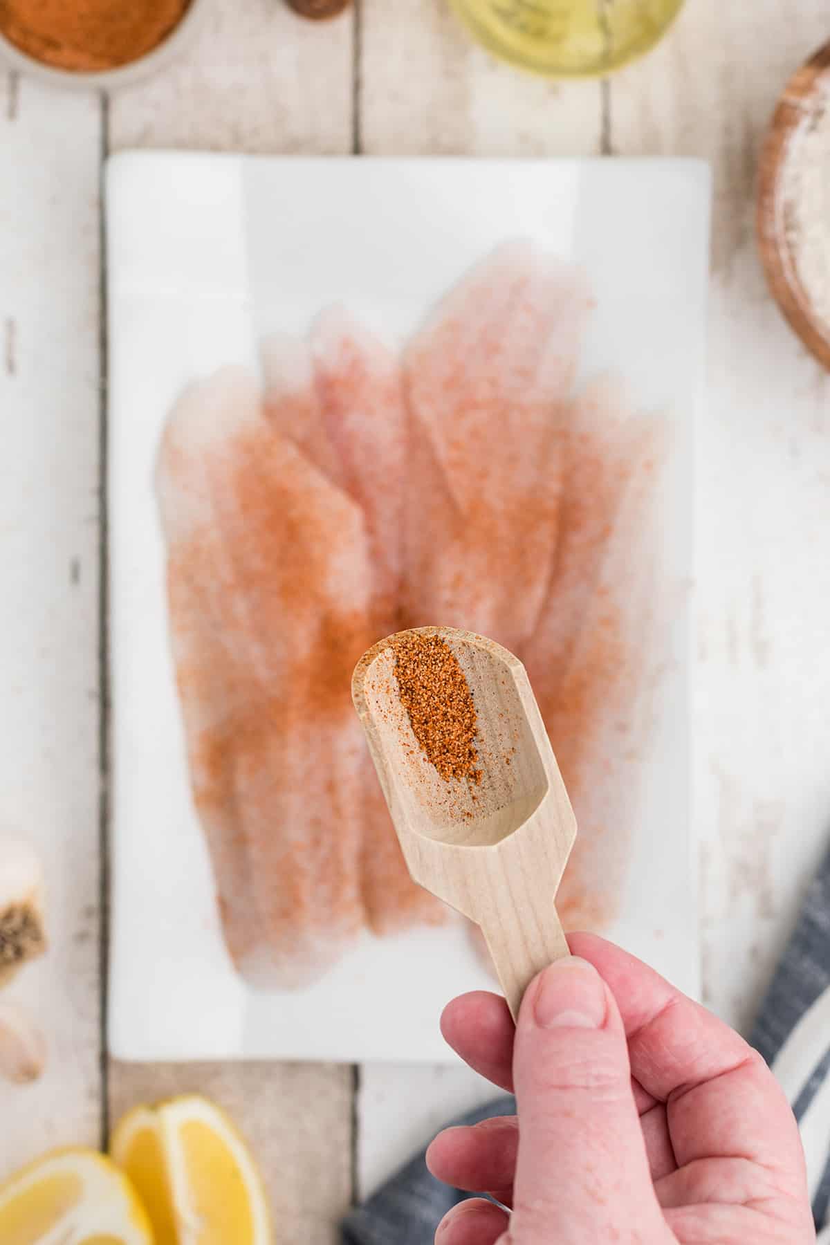 Fish fillets being seasoned.