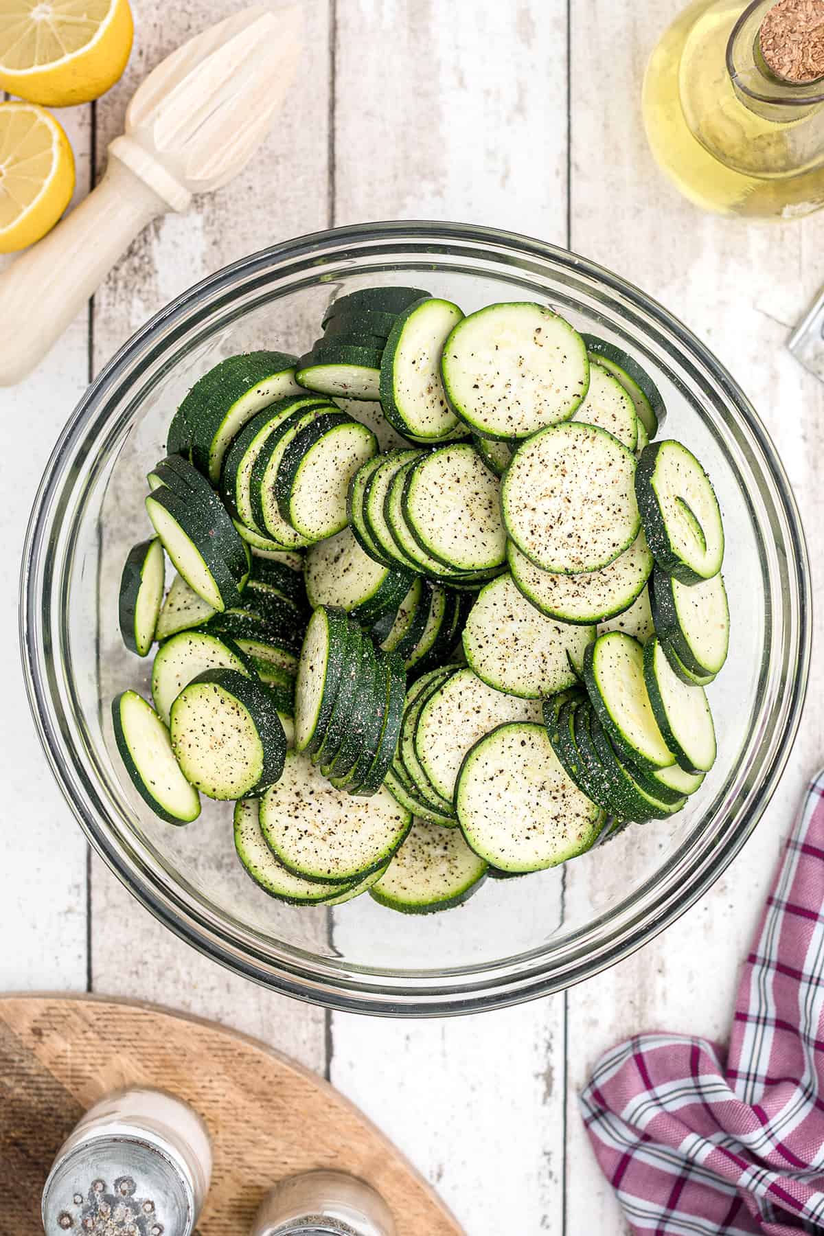 Seasoned zucchini slices in a bowl.