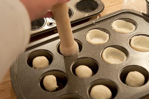 Forming tart shells in a miniature muffin tin.