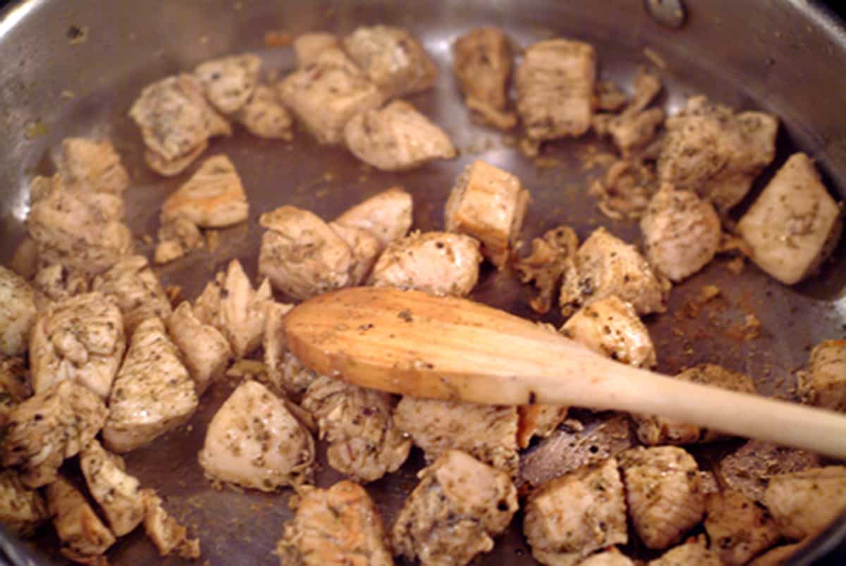 Browning chicken in a skillet.