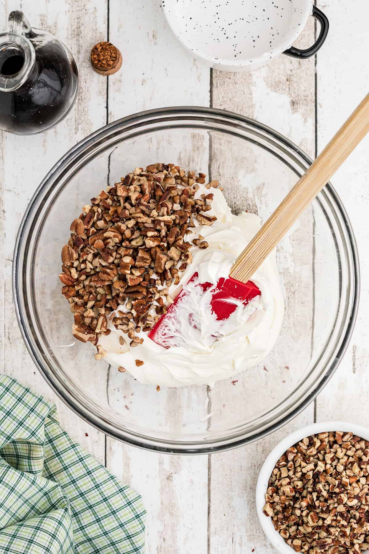 Adding chopped pecans to the icing.