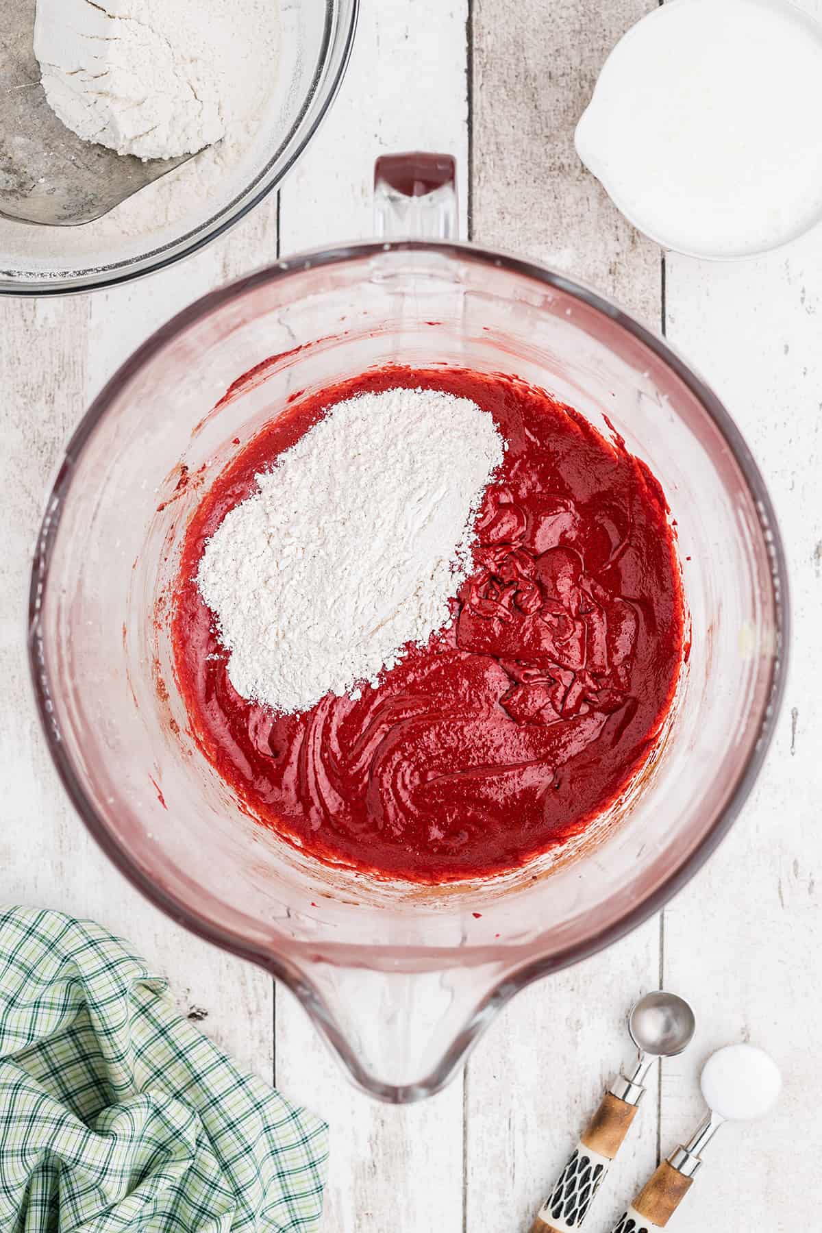 Alternately adding flour to the creamed mixture.