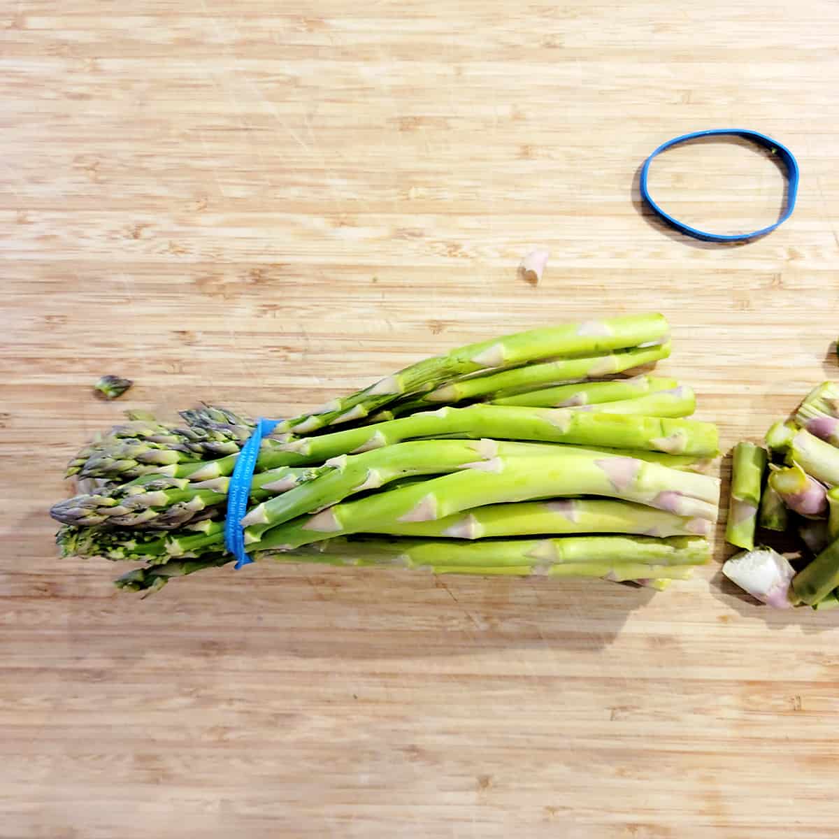 A bundle of fresh asparagus with the ends trimmed.