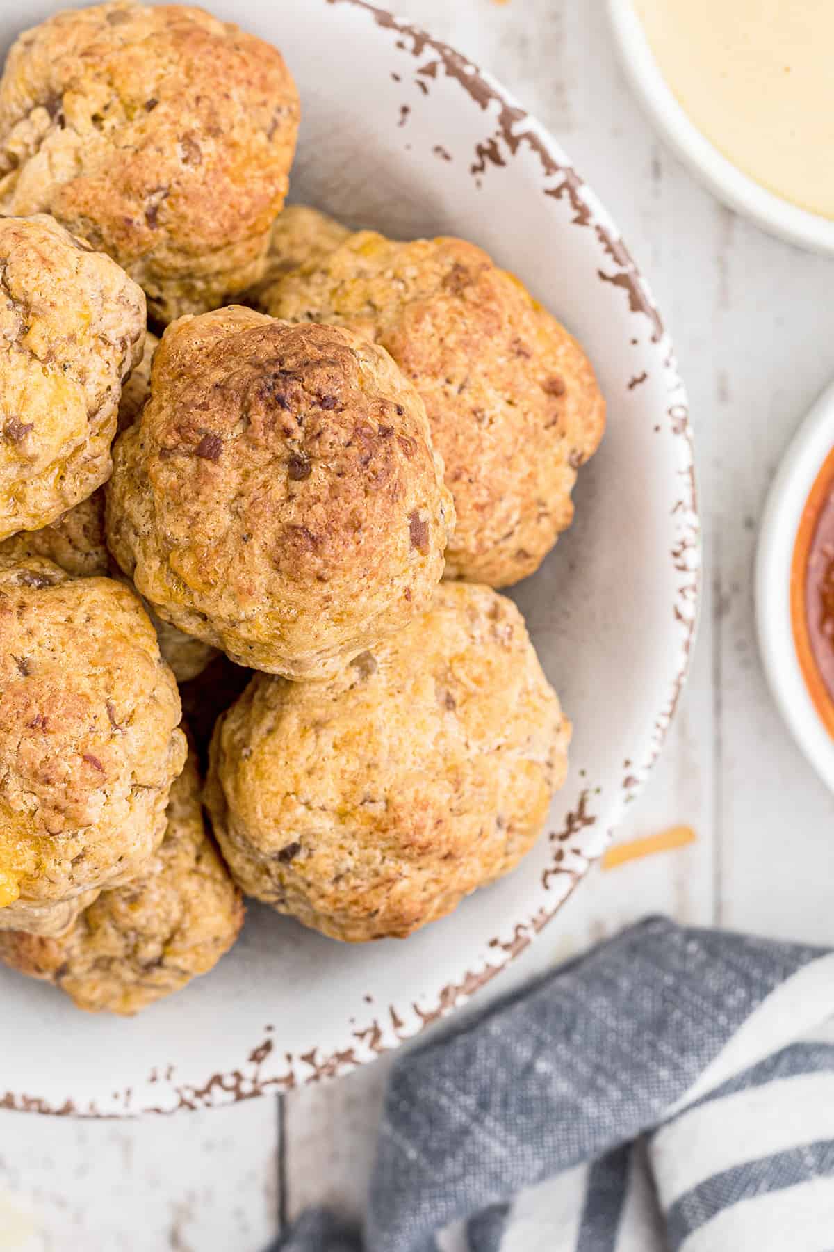 Finished sausage balls in a white serving bowl.