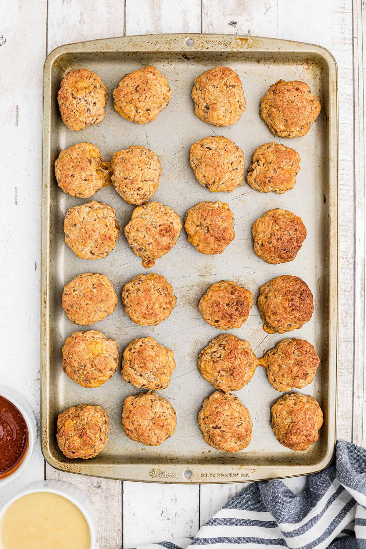 Cooked sausage balls on a baking sheet.