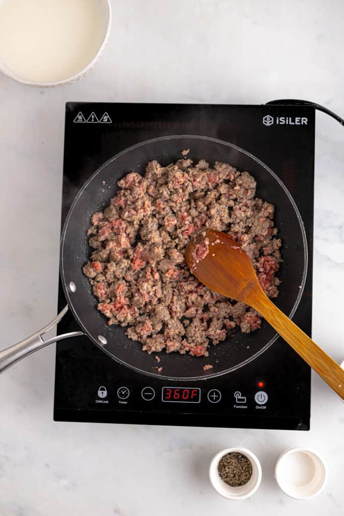 Sausage cooking in a skillet.