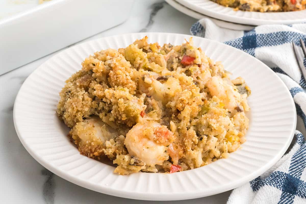 A serving of seafood casserole on a white plate.