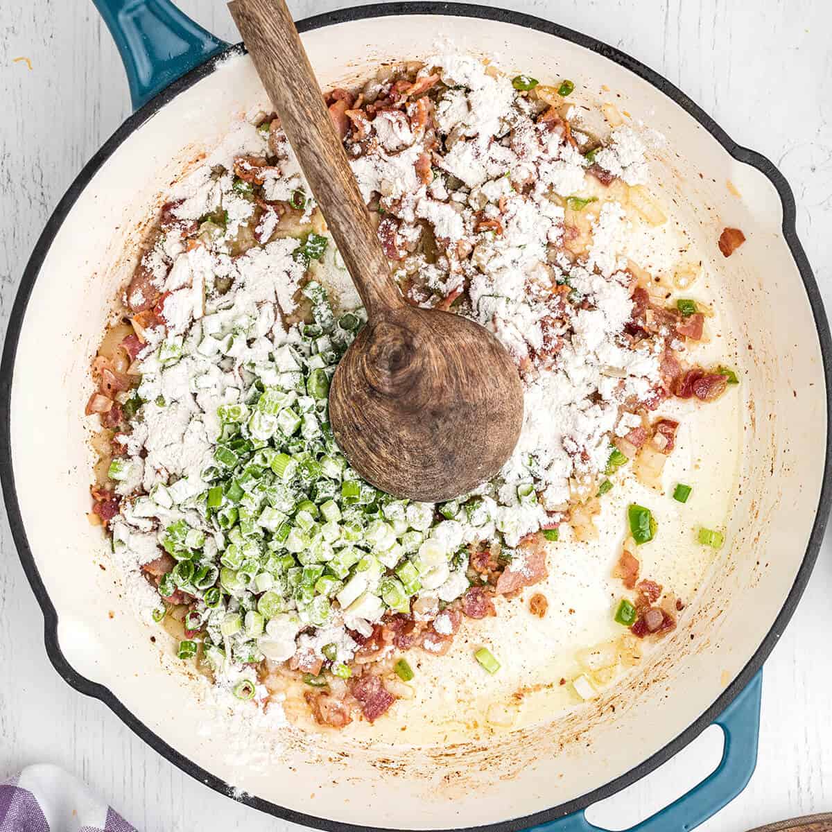 Scallions and flour added to the skillet.