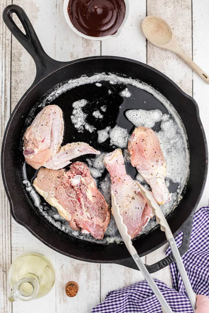 Browning chicken on the first side in butter and oil.