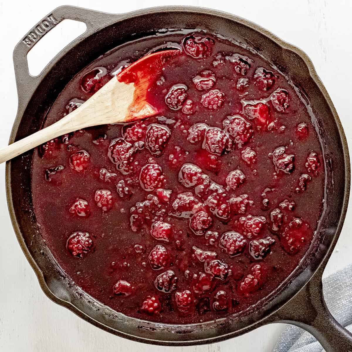 Blackberry filling in a cast iron skillet.