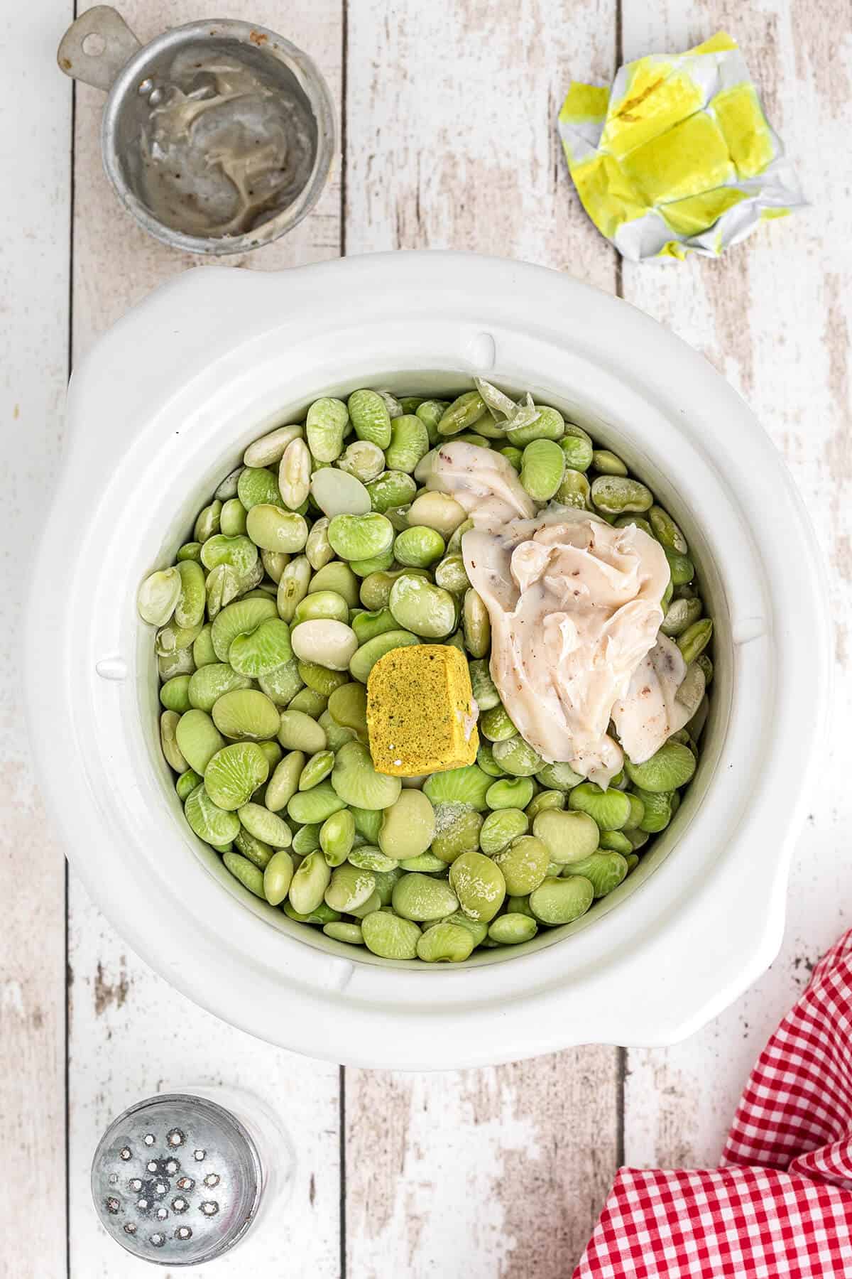 Butter beans, bacon fat, chicken bouillon, salt, and water in a small slow cooker.