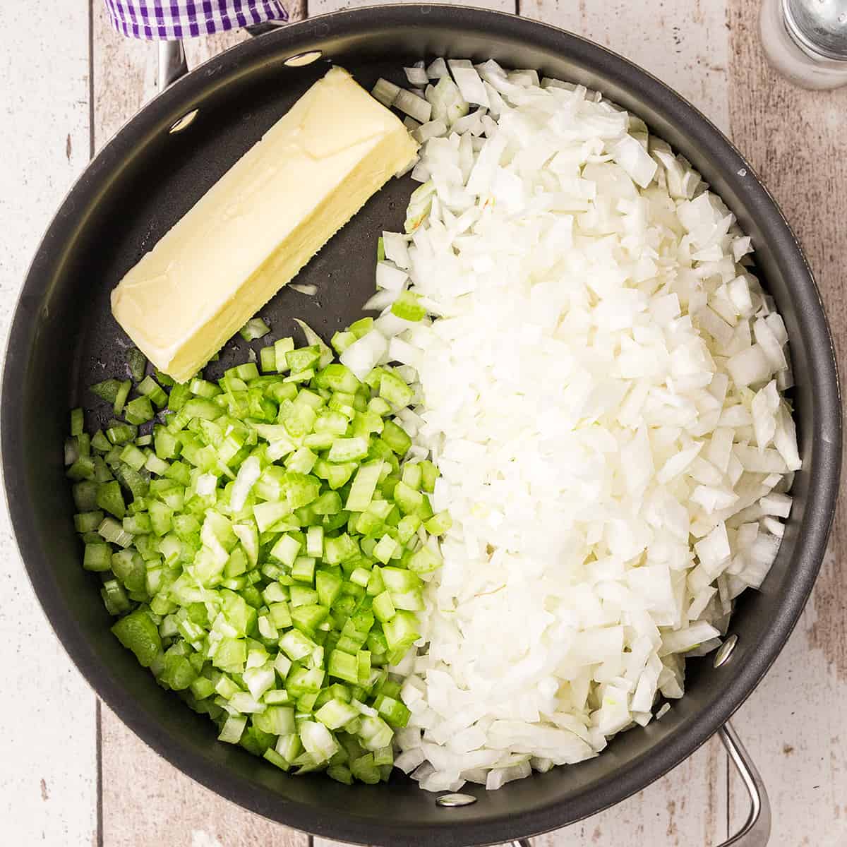 Chopped onions, chopped celery, and butter in a cast iron skillet.