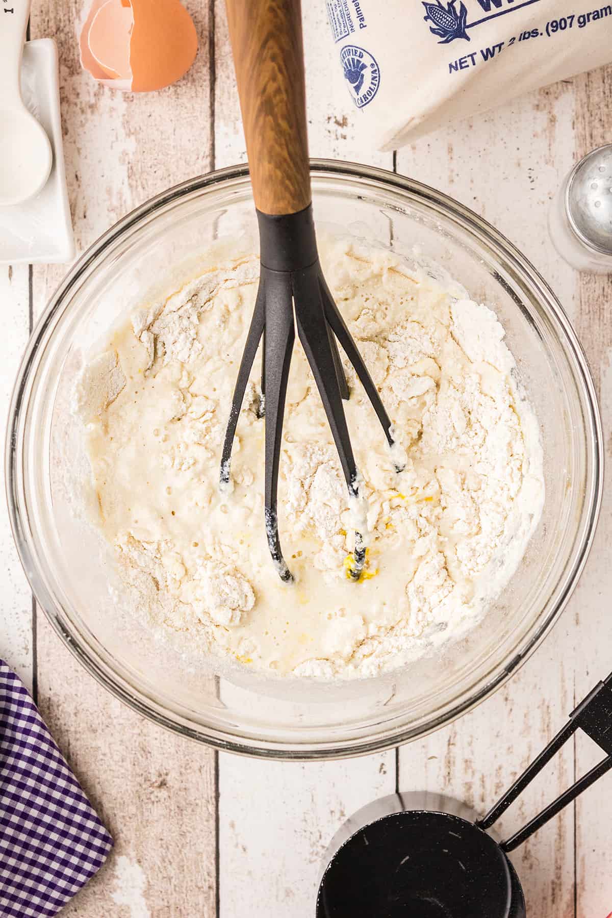 Egg bread ingredients being mixed with a whisk in a bowl.