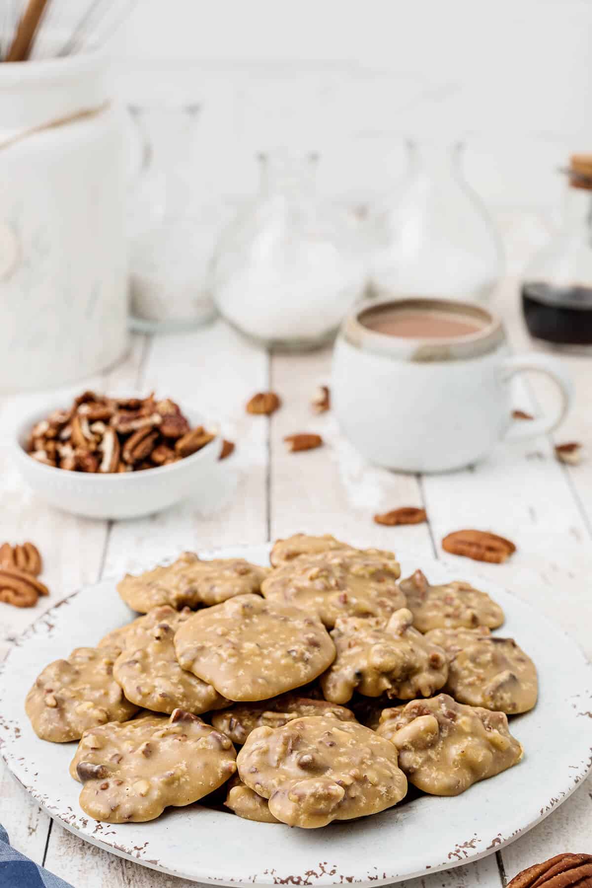 Pecan pralines on a white serving plate.