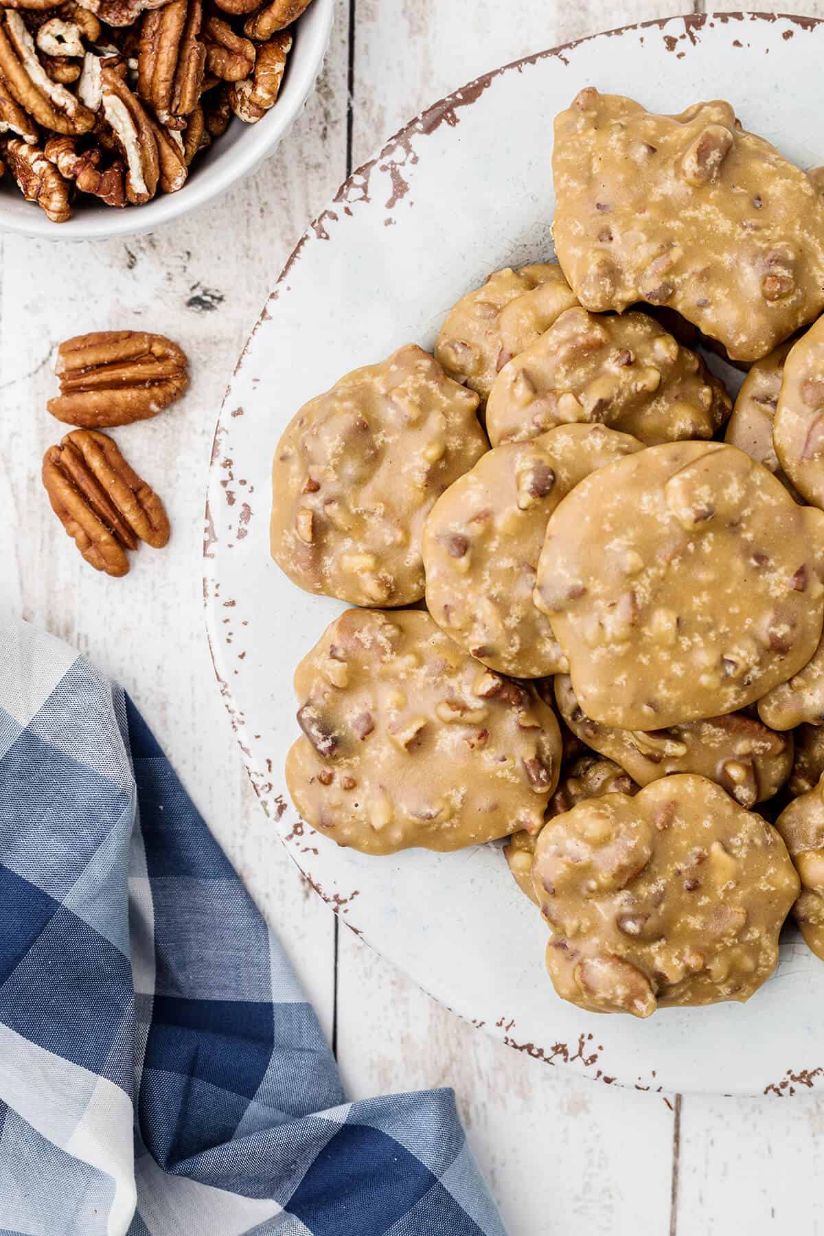 Pecan pralines on a white serving plate.