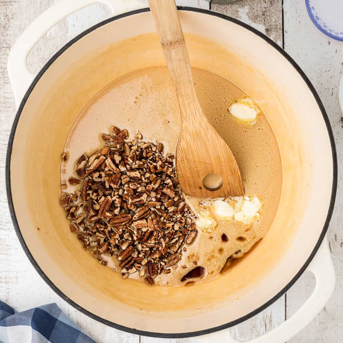 Pecans, butter, and vanilla added to candy mixture.