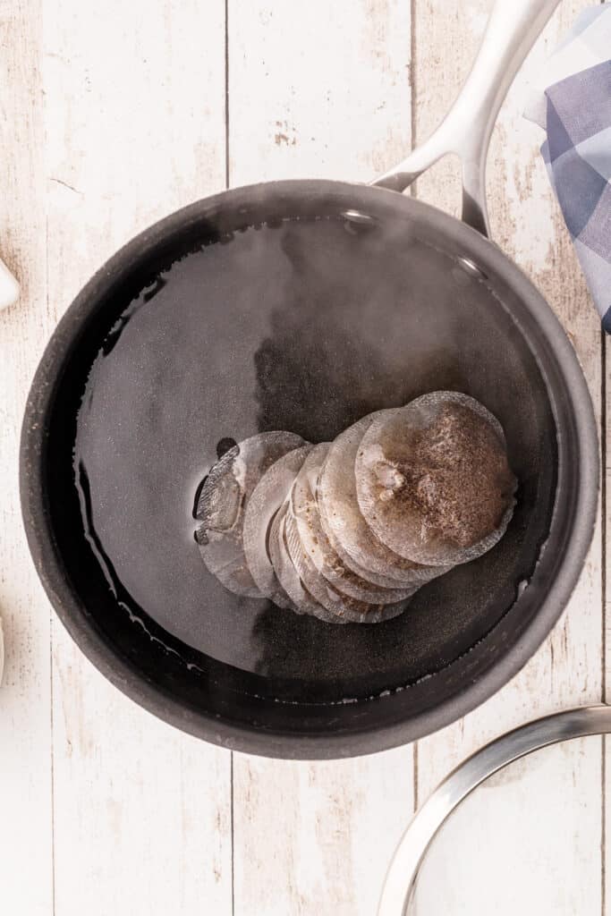 Water and tea bags in a pot.