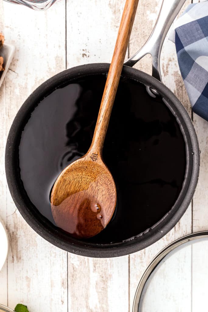 Wooden spoon and finished tea in pot.